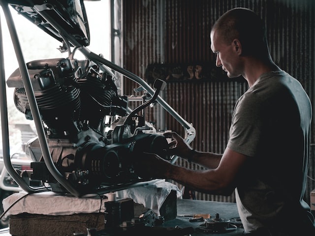 A car mechanic repairing an engine