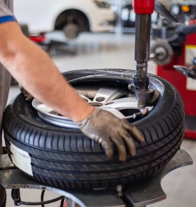 a mechanic removing a rim from a tire.